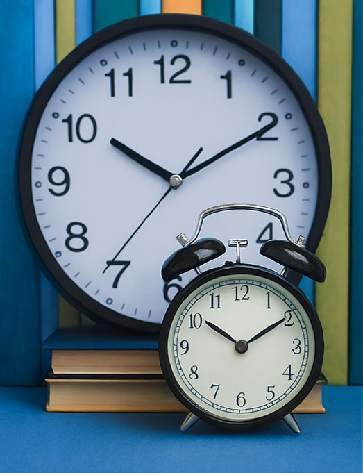 School clock and books